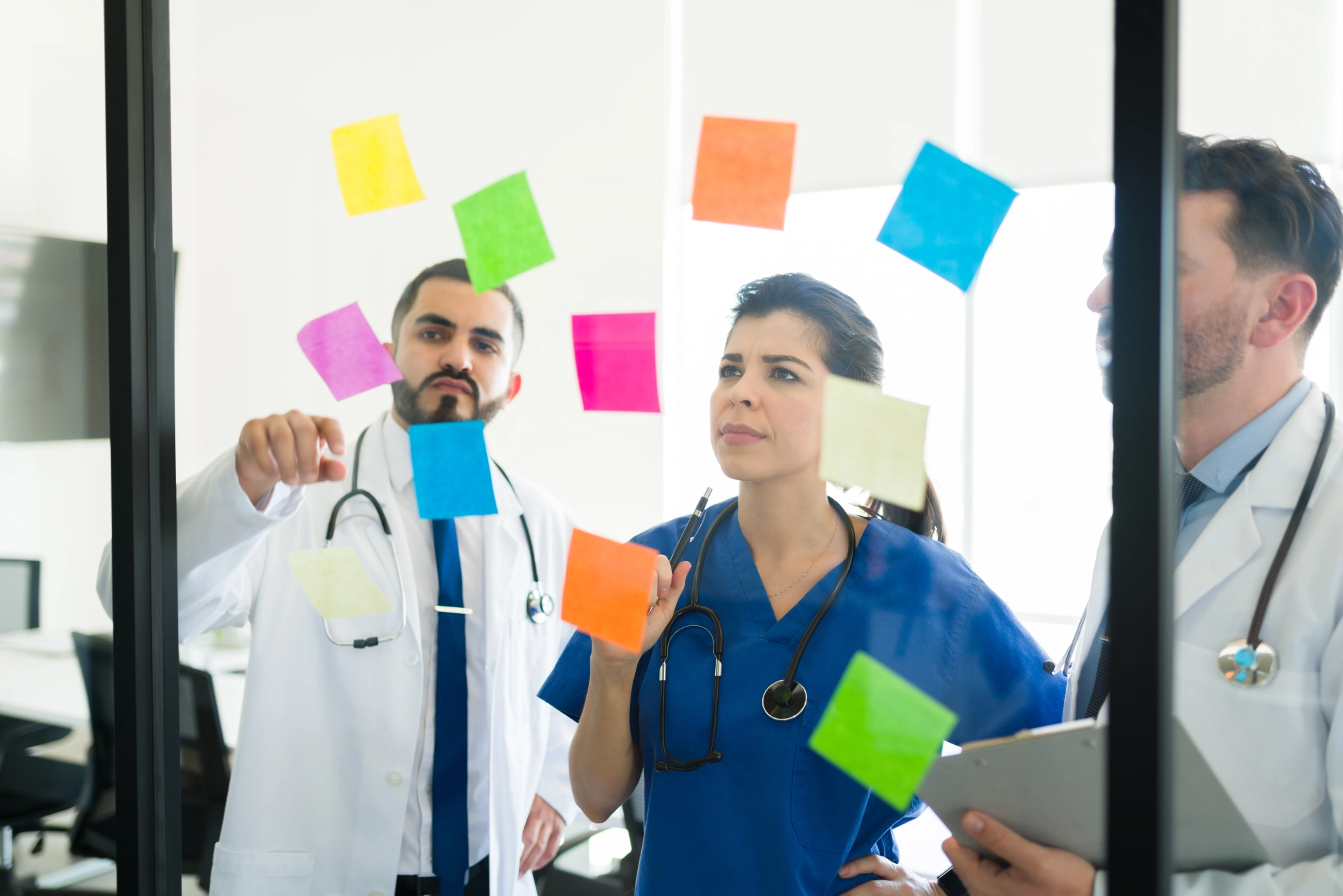 medical-board-brainstorming-together-meeting-room-doctors-nurse-writing-memos-sticky-notes